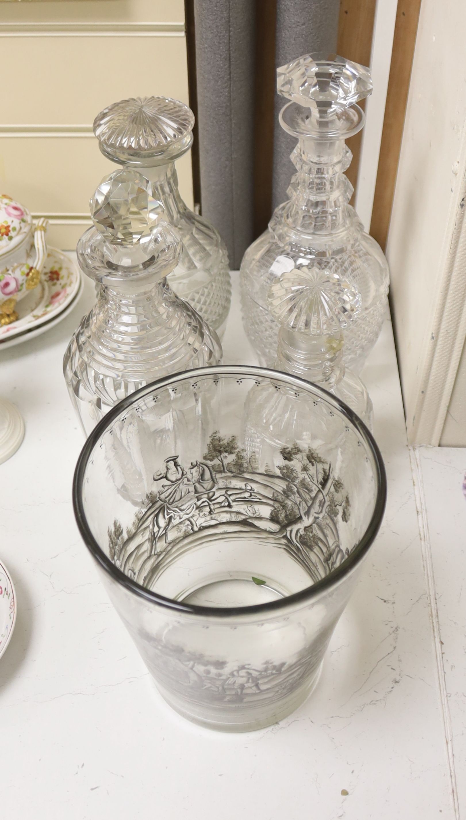 A glass vase with enamelled hunting scene with sundry decanters